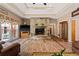 Living room with hardwood floors, stone fireplace, and natural lighting at 7180 Westray Rd, Cumming, GA 30028