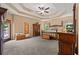 Spacious main bedroom with tray ceiling, carpet floors, and private patio access at 7180 Westray Rd, Cumming, GA 30028
