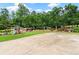 Play area with swing set and playhouse, set amidst a green lawn at 7180 Westray Rd, Cumming, GA 30028