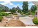 Gorgeous outdoor space with pool, slide, hot tub, patio, and landscaping at 7180 Westray Rd, Cumming, GA 30028