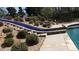 Ingenious pool design featuring a tiled slide and steps leading to a refreshing pool at 7180 Westray Rd, Cumming, GA 30028