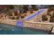 Backyard pool with tiled water slide surrounded by lush landscaping and stone accents at 7180 Westray Rd, Cumming, GA 30028