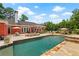 Swimming pool, a spa and an outdoor kitchen with patio furniture at 7180 Westray Rd, Cumming, GA 30028