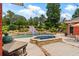 Outdoor pool area featuring a water slide and hot tub at 7180 Westray Rd, Cumming, GA 30028