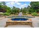 Backyard pool area with water slide feature, outdoor grill, and hot tub at 7180 Westray Rd, Cumming, GA 30028