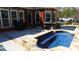 Outdoor hot tub with custom stone surround, perfect for relaxation and entertaining at 7180 Westray Rd, Cumming, GA 30028