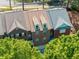 Aerial view of townhomes, with trees surrounding, highlighting roof and dormer windows at 144 Wetherbrooke Ln # 4, Smyrna, GA 30082