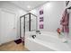 Well-maintained bathroom with a soaking tub, glass-enclosed shower, and neutral tile flooring at 144 Wetherbrooke Ln # 4, Smyrna, GA 30082