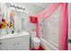 Bright bathroom featuring a shower with a pink curtain, white tiling, and a modern white vanity at 144 Wetherbrooke Ln # 4, Smyrna, GA 30082