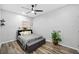 Modern bedroom featuring hardwood floors, a storage bench and a large window for natural light at 144 Wetherbrooke Ln # 4, Smyrna, GA 30082