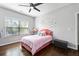 Bright, well-lit bedroom with a bed, hardwood floors, and modern ceiling fan at 144 Wetherbrooke Ln # 4, Smyrna, GA 30082