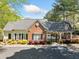 Community clubhouse featuring brick and siding exterior, covered entrance, and manicured landscaping at 144 Wetherbrooke Ln # 4, Smyrna, GA 30082