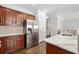 Modern kitchen features stainless steel appliances, marble countertops, and custom cabinetry at 144 Wetherbrooke Ln # 4, Smyrna, GA 30082