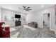 Modern living room with a ceiling fan, grey sofa, abstract rug and large windows for natural light at 144 Wetherbrooke Ln # 4, Smyrna, GA 30082