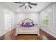 Bright primary bedroom with hardwood floors, decorative wall trim, and modern ceiling fan at 144 Wetherbrooke Ln # 4, Smyrna, GA 30082