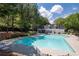 Community pool area featuring chairs and a well-maintained pool surrounded by trees at 144 Wetherbrooke Ln # 4, Smyrna, GA 30082