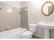 Cozy bathroom featuring a white pedestal sink, a round mirror and tiled walls at 1665 Little Lisa Ln, Snellville, GA 30078