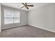 Empty bedroom showcasing a ceiling fan and carpet flooring at 1665 Little Lisa Ln, Snellville, GA 30078