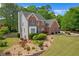 View of the house showing brick and siding and landscaping, with a manicured front lawn at 1665 Little Lisa Ln, Snellville, GA 30078