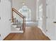 Entryway with wood floors leading to carpeted living area with a staircase and large bright window at 1665 Little Lisa Ln, Snellville, GA 30078