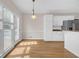 Bright kitchen area with hardwood floors, white cabinets, granite counters and stainless appliances at 1665 Little Lisa Ln, Snellville, GA 30078