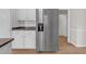 Bright kitchen with stainless steel refrigerator, granite countertops, and white cabinets at 1665 Little Lisa Ln, Snellville, GA 30078