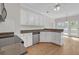 Bright kitchen featuring granite counters, stainless steel appliances, and white cabinetry at 1665 Little Lisa Ln, Snellville, GA 30078