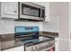 Modern kitchen appliances including a stainless steel microwave and oven at 1665 Little Lisa Ln, Snellville, GA 30078