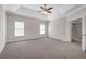 Large main bedroom with tray ceiling, ceiling fan, and carpet floor at 1665 Little Lisa Ln, Snellville, GA 30078