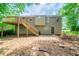 Backyard view of a home with a wooden deck and staircase leading to a spacious yard at 2132 Sara Ashley Way, Lithonia, GA 30058