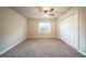 This bedroom features neutral paint, carpet flooring, a ceiling fan and a double door closet at 2132 Sara Ashley Way, Lithonia, GA 30058