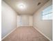 This bedroom features neutral paint, carpet flooring, a single window and two doors at 2132 Sara Ashley Way, Lithonia, GA 30058