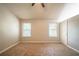 Comfortable bedroom featuring neutral walls, two large windows, and plush carpeting at 2132 Sara Ashley Way, Lithonia, GA 30058