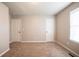 Neutral carpeted bedroom with two doors and a window at 2132 Sara Ashley Way, Lithonia, GA 30058