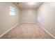 Bedroom featuring neutral paint and carpet flooring plus a window for natural light at 2132 Sara Ashley Way, Lithonia, GA 30058