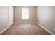 Neutral bedroom with a window, closet, and carpeting at 2132 Sara Ashley Way, Lithonia, GA 30058