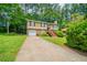 Charming split-level home with a brick facade, a wooden staircase, and an attached garage at 2132 Sara Ashley Way, Lithonia, GA 30058