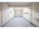 Attached garage with a painted floor and walls, shelving and an electric garage door at 2132 Sara Ashley Way, Lithonia, GA 30058