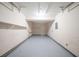 Attached garage with painted floors, walls, shelving and a door to access the home at 2132 Sara Ashley Way, Lithonia, GA 30058