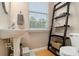 Cozy half-bathroom with modern fixtures and a ladder shelf at 2513 Ivey Crest Cir, Tucker, GA 30084