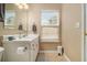Bright bathroom with a single sink vanity, window, and neutral decor at 2513 Ivey Crest Cir, Tucker, GA 30084