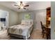 Cozy bedroom featuring a ceiling fan, desk and a bed with a patterned comforter at 2513 Ivey Crest Cir, Tucker, GA 30084