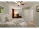Comfortable bedroom with a ceiling fan, desk and a bed with a patterned comforter at 2513 Ivey Crest Cir, Tucker, GA 30084