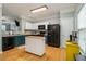 Well-lit kitchen boasts white and dark-teal cabinets and black appliances at 2513 Ivey Crest Cir, Tucker, GA 30084