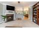 Open-concept living room featuring a fireplace, built-in shelving, and seamless flow to the dining area at 2513 Ivey Crest Cir, Tucker, GA 30084