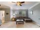 Comfortable living room with large windows, neutral decor, and a ceiling fan at 2513 Ivey Crest Cir, Tucker, GA 30084