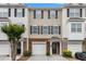 Well-maintained townhouse exterior featuring brick accents and convenient attached garages at 2513 Ivey Crest Cir, Tucker, GA 30084