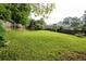 Large backyard with manicured lawn and privacy fence, perfect for relaxation and recreation at 620 Shannon Green Sw Cir, Mableton, GA 30126