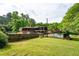 Spacious backyard featuring a well-maintained lawn and mature trees, enhancing privacy at 620 Shannon Green Sw Cir, Mableton, GA 30126