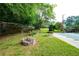 Landscaped backyard featuring a fire pit and lush green grass, ideal for outdoor enjoyment at 620 Shannon Green Sw Cir, Mableton, GA 30126